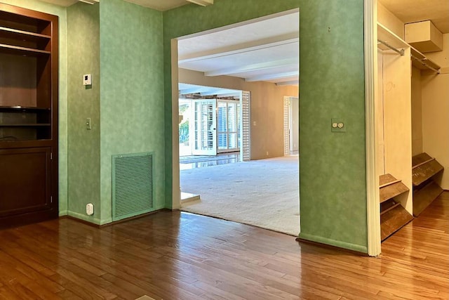 interior space featuring beam ceiling and wood-type flooring