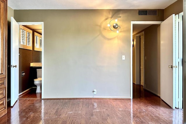 spare room with wood-type flooring