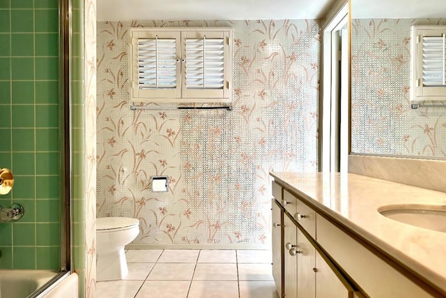 full bathroom featuring toilet, combined bath / shower with glass door, tile patterned floors, and vanity