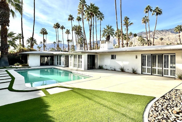 back of house featuring a mountain view and a patio