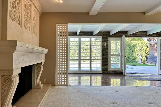 carpeted living room with beam ceiling and a premium fireplace