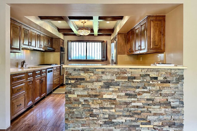 kitchen with appliances with stainless steel finishes, sink, hanging light fixtures, beam ceiling, and coffered ceiling