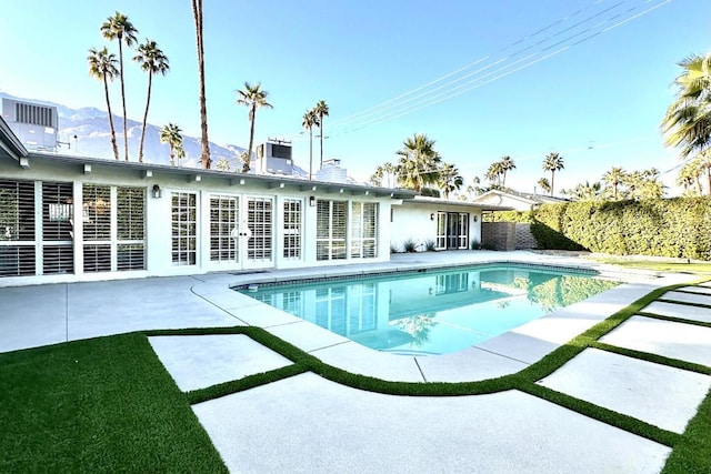 view of pool with a mountain view and a patio