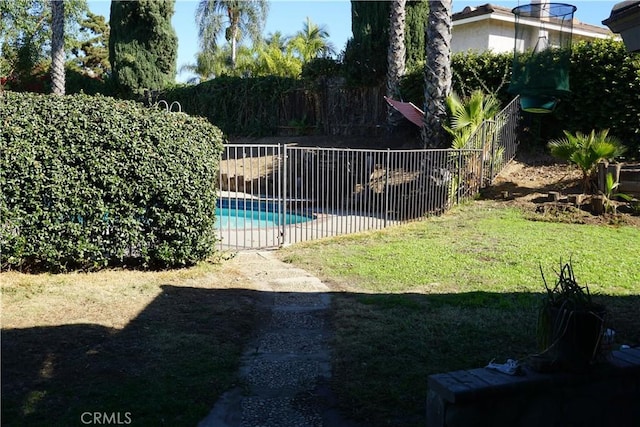 view of swimming pool with a lawn