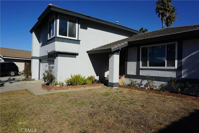 view of front of house with a front yard and a garage