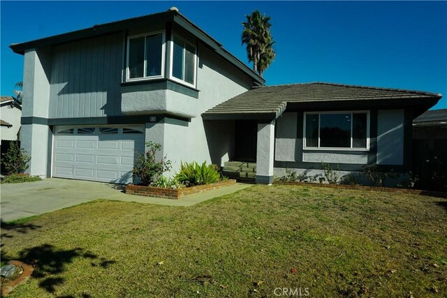 view of front facade with a front yard and a garage