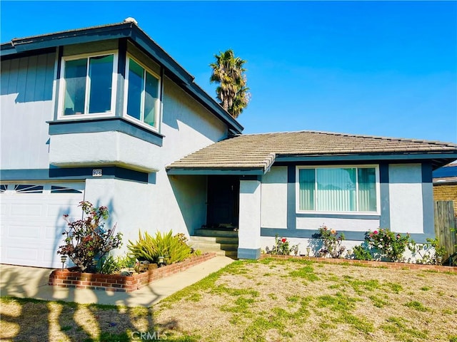 view of front of property with a garage and a front lawn