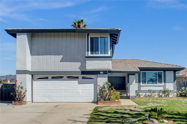 view of front of home with a front lawn, an attached garage, concrete driveway, and stucco siding