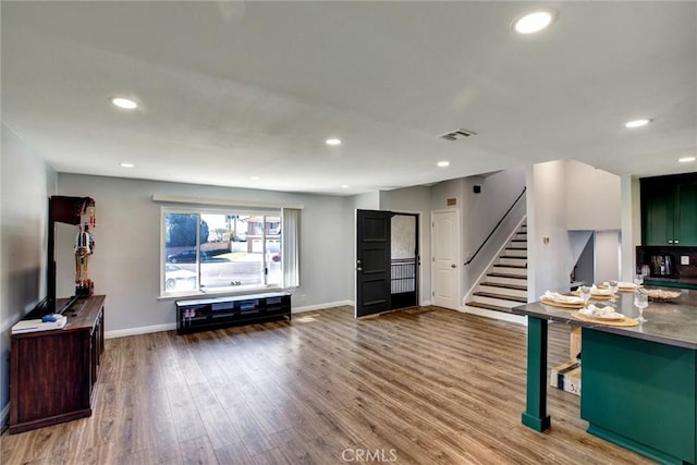 interior space featuring recessed lighting, stairway, and wood finished floors