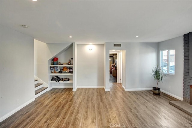 interior space with visible vents, wood finished floors, recessed lighting, stairway, and baseboards