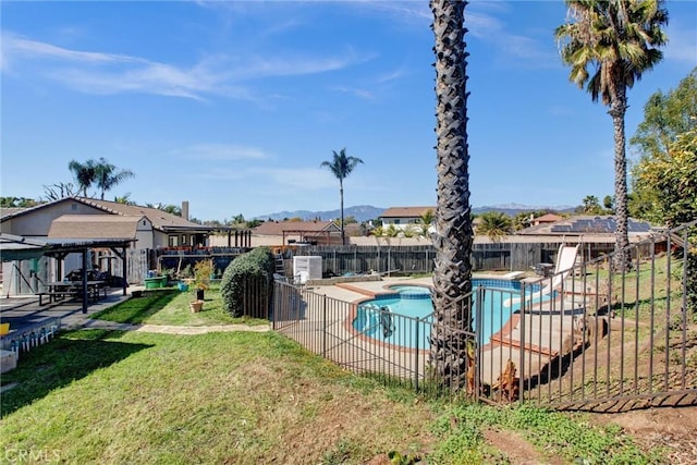 view of swimming pool with a fenced in pool, a water slide, a yard, a fenced backyard, and a patio