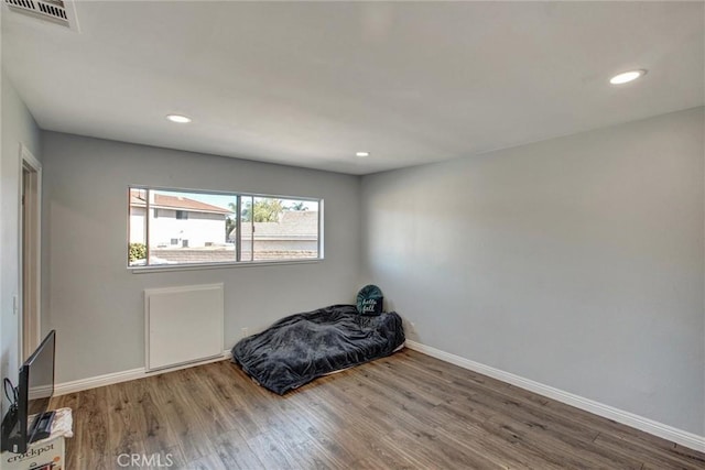 interior space featuring visible vents, recessed lighting, baseboards, and wood finished floors