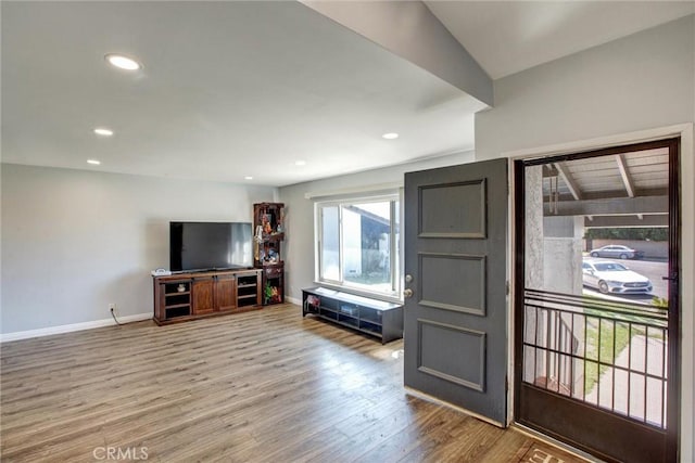 living room featuring recessed lighting, wood finished floors, and baseboards