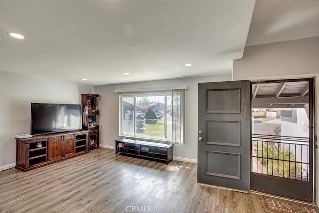 living room with recessed lighting, baseboards, and wood finished floors