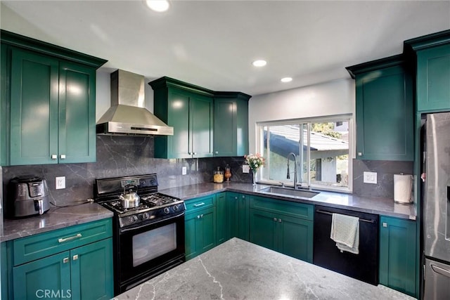 kitchen featuring green cabinetry, a sink, black appliances, wall chimney range hood, and backsplash