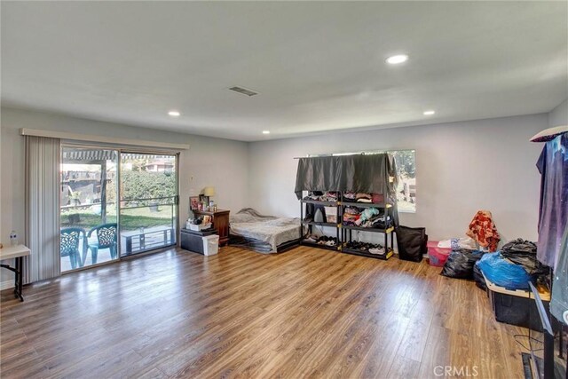 bedroom featuring access to exterior, visible vents, recessed lighting, and wood finished floors