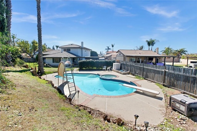 view of pool with a residential view, a pool with connected hot tub, a fenced backyard, and a patio area