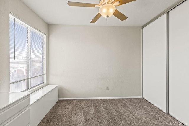 unfurnished bedroom featuring carpet flooring, ceiling fan, and a closet