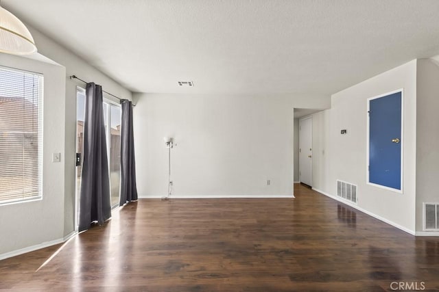 unfurnished room featuring dark hardwood / wood-style floors