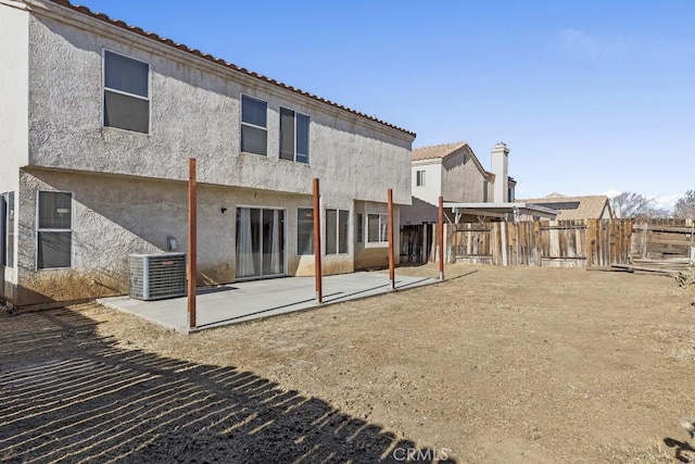 back of property featuring central AC and a patio area