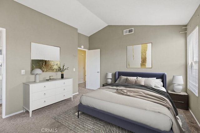 carpeted bedroom with vaulted ceiling