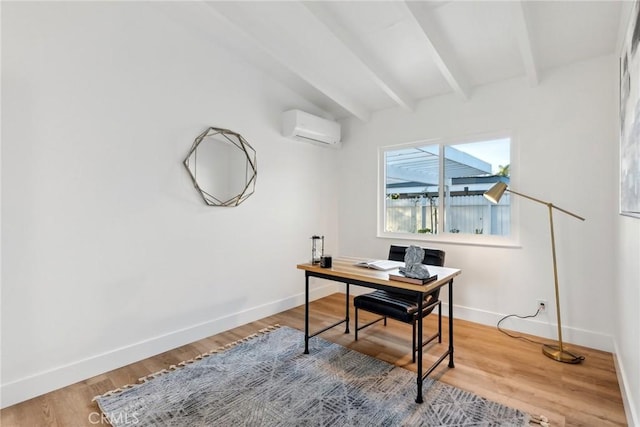 office area featuring beamed ceiling, hardwood / wood-style floors, and a wall unit AC