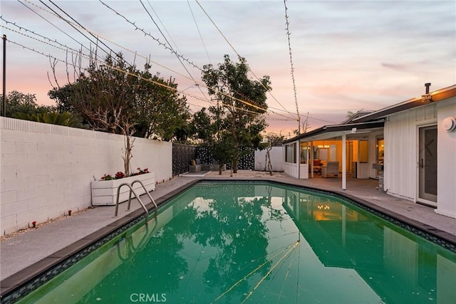 view of pool at dusk