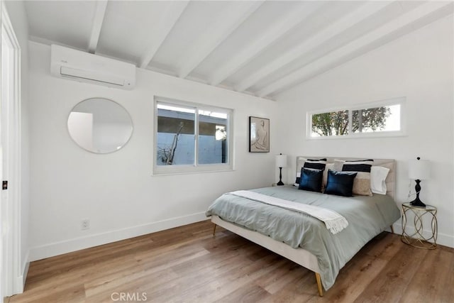 bedroom featuring hardwood / wood-style flooring, a wall mounted AC, and lofted ceiling with beams