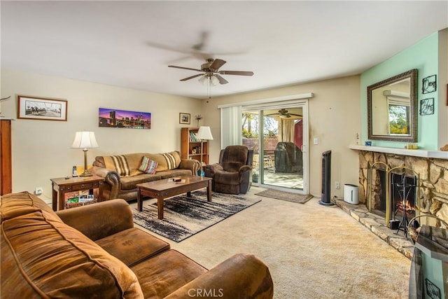 living room with carpet, a fireplace, and ceiling fan