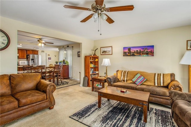 living room featuring light carpet and ceiling fan