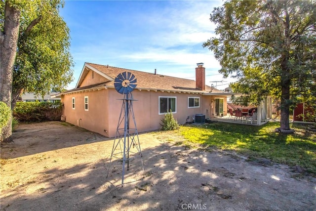 rear view of property featuring cooling unit and a patio