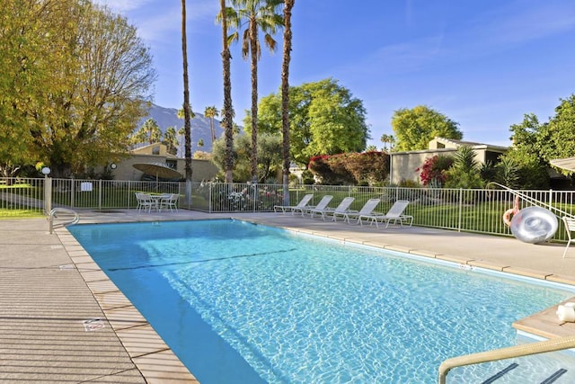 view of swimming pool with a patio area and a mountain view