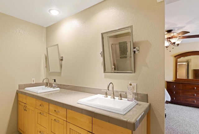 bathroom with ceiling fan and vanity