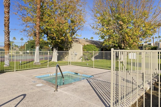 view of pool with a hot tub