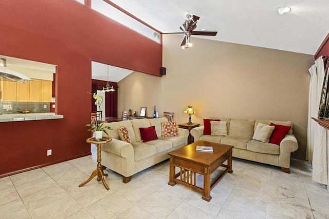 living room with ceiling fan with notable chandelier and vaulted ceiling