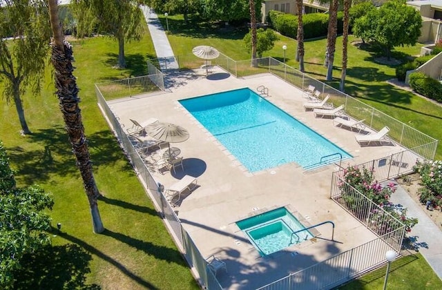 view of swimming pool featuring a lawn and a patio