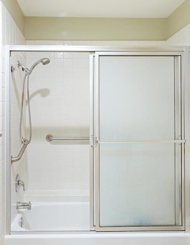 bathroom with shower / bath combination with glass door