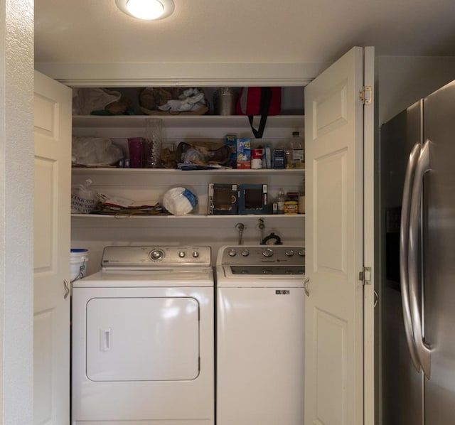 laundry area featuring washing machine and clothes dryer