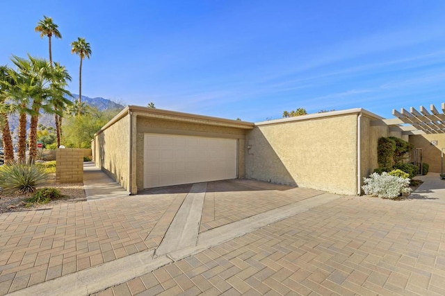 view of front of property featuring a garage and a mountain view