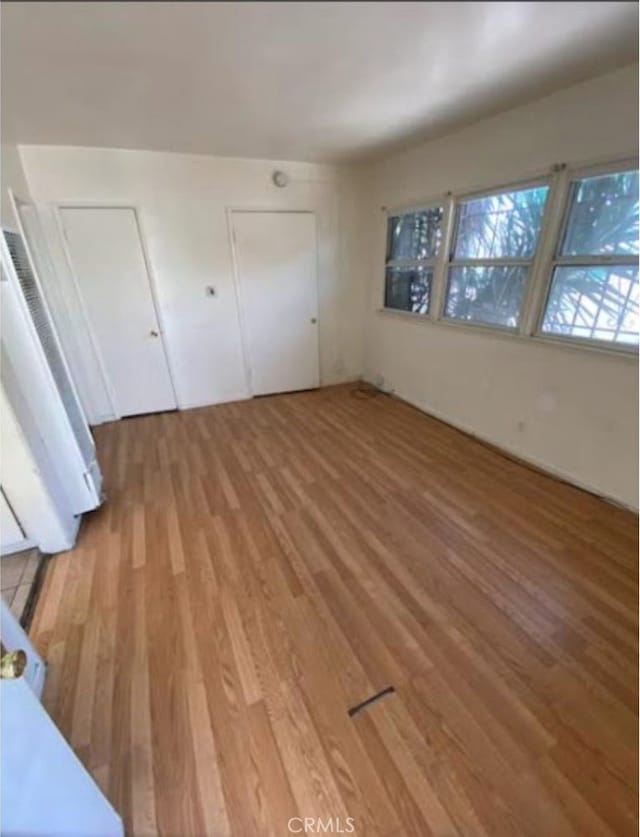 unfurnished bedroom with wood-type flooring