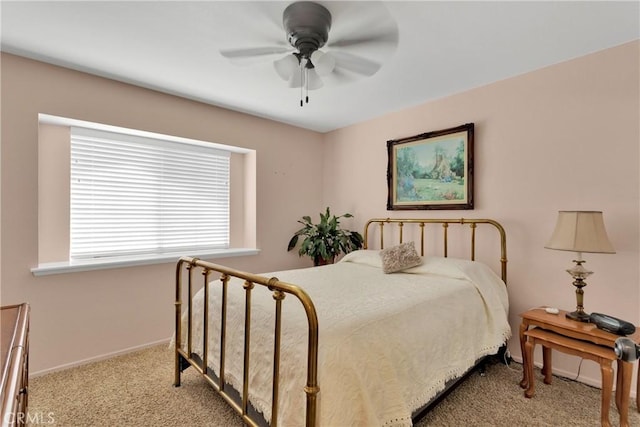 bedroom with ceiling fan and light carpet