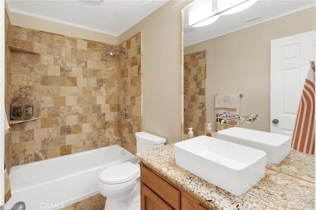 full bathroom featuring toilet, vanity, and tiled shower / bath