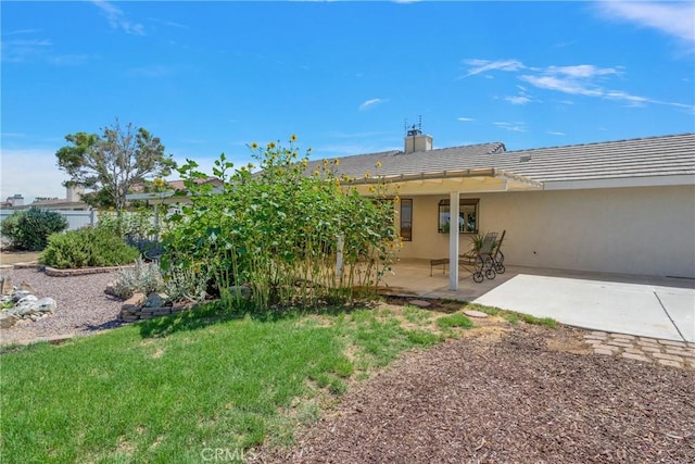 rear view of house with a patio area and a lawn