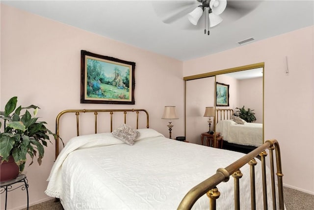 carpeted bedroom featuring ceiling fan and a closet