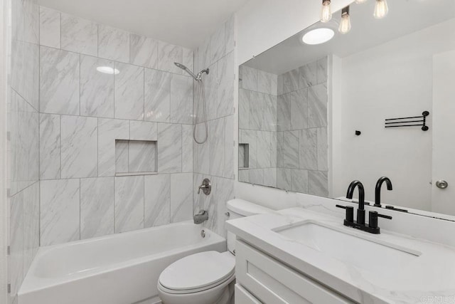 full bathroom with toilet, tiled shower / bath combo, and vanity