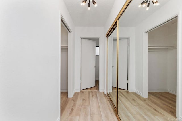 interior space with light hardwood / wood-style flooring and a notable chandelier