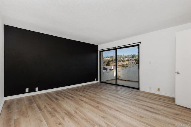 spare room with light wood-type flooring