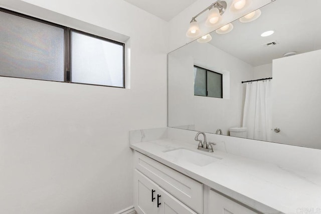 bathroom with toilet and vanity