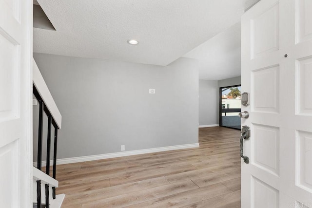 entrance foyer featuring a textured ceiling and light hardwood / wood-style flooring