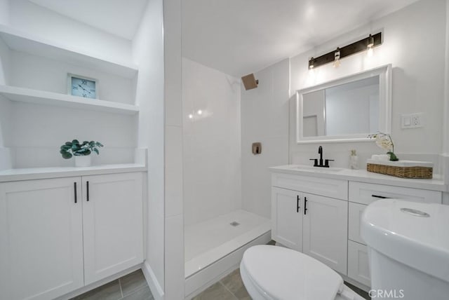 bathroom featuring vanity, toilet, and walk in shower